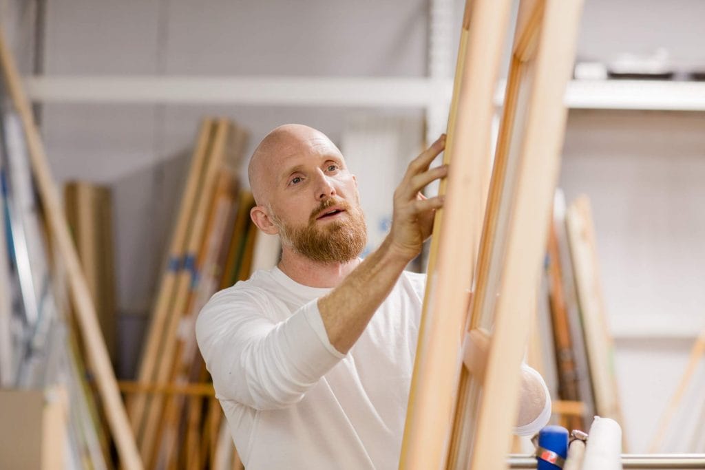 young man shopping for lumber at Habitat ReStore